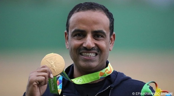 epa05471576 Fehaid Aldeehani of the IOA poses with his gold medal on the podium after winning  the Rio 2016 Olympic Games Men's Double Trap Shooting event at the Olympic Shooting Centre in Rio de Janeiro, Brazil, 10 August 2016.  EPA/ARMANDO BABANI