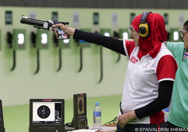 epa05461578 Olfa Charni of Tunisia takes aim during the women's 10m Air Pistol qualification of the Rio 2016 Olympic Games Shooting events at the Olympic Shooting Centre in Rio de Janeiro, Brazil, 07 August 2016.  EPA/VALDRIN XHEMAJ