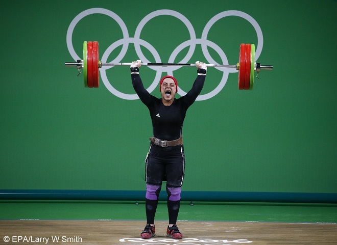 epa05471774 Sara Ahmed of Egypt in action during the women's 48kg category of the Rio 2016 Olympic Games Weightlifting events at the Riocentro in Rio de Janeiro, Brazil, 10  August 2016.  EPA/Larry W Smith