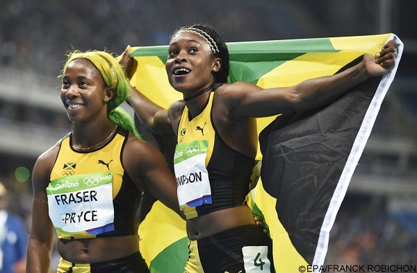 epaselect epa05482648 Elaine Thompson of Jamaica celebrates after winning the women's 100m final of the Rio 2016 Olympic Games Athletics, Track and Field events at the Olympic Stadium in Rio de Janeiro, Brazil, 13 August 2016. At left is Shelly-Ann Fraser-Pryce of Jamaica who placed third.  EPA/FRANCK ROBICHON