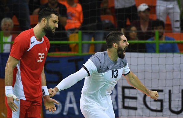 epa05463628 France's Nikola Karabatic (R) celebrates a goal during the men's Handball preliminary round match between France and Tunisia at the Rio 2016 Olympic Games at the Future Arena in the Olympic Park in Rio de Janeiro, Brazil, 07 August 2016.  EPA/MARIJAN MURAT