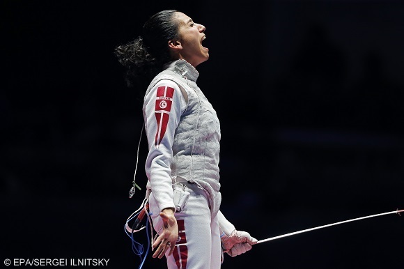 epa05472338 Ines Boubakri of Tunisia celebrates after defeating Aida Shanaeva of Russia in the women's Foil individual bronze medal bout of the Rio 2016 Olympic Games Fencing events at the Carioca Arena 3 in the Olympic Park in Rio de Janeiro, Brazil, 10 August 2016.  EPA/SERGEI ILNITSKY