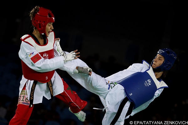 epa05497765 Raheleh Asemani of Belgium (blue) and Naima Bakkal (red) of Morocco in action during women's -57kg Repechage bout of the Rio 2016 Olympic Games Taekwondo events at the Carioca Arena 3 in the Olympic Park in Rio de Janeiro, Brazil, 18 August 2016.  EPA/TATYANA ZENKOVICH