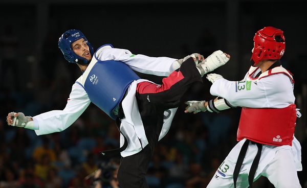 epa05500979 Steven Lopez of the USA (Red) and Oussama Oueslati of Tunisia (Blue) in action during the men's -80kg bronze medal bout of the Rio 2016 Olympic Games Taekwondo events at the Carioca Arena 3 in the Olympic Park in Rio de Janeiro, Brazil, 19 August 2016.  EPA/TATYANA ZENKOVICH